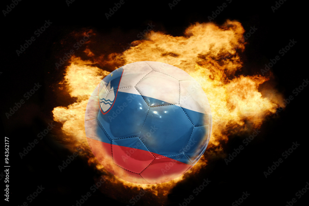 Fototapeta premium football ball with the flag of slovenia on fire