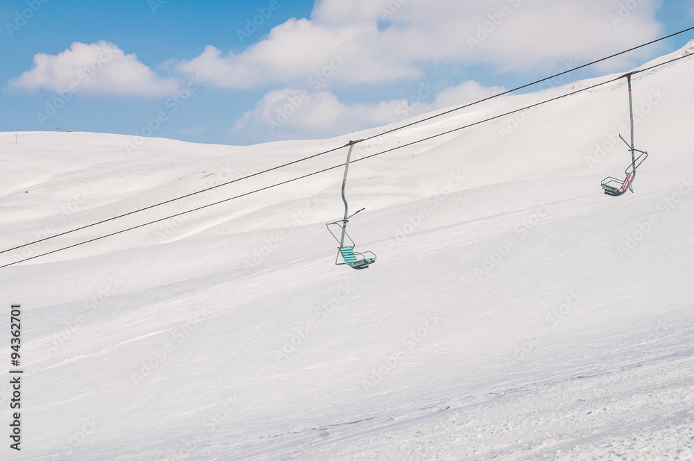 Ski lifts durings bright winter day Ski lifts durings bright winter day
