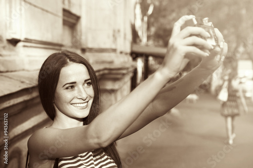 Pretty girl taking selfie on the street