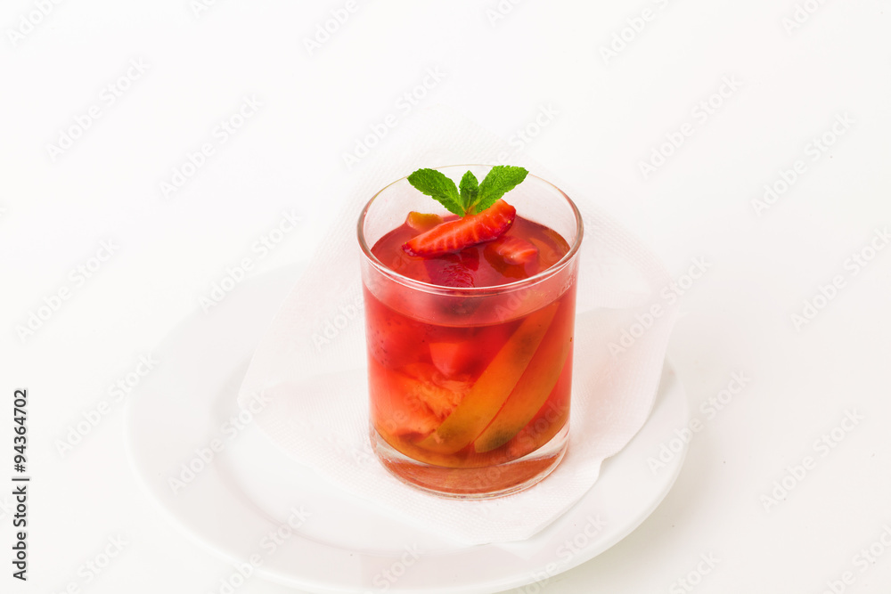 glass compote with strawberries, apples and mint, fruit, pear, jelly, juice, isolated on a white background for the menu glass compote with strawberries, apples and mint, fruit, pear, jelly, juice, isolated on a white background for the menu