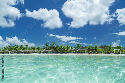 Fototapeta Naklejka Na Ścianę i Meble -  stunning splendid amazing inviting view of Cuban, Cayo Coco beach from the tranquil turquoise ocean side, with people in background