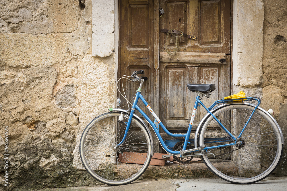 antique bicycle and an ancient wooden door