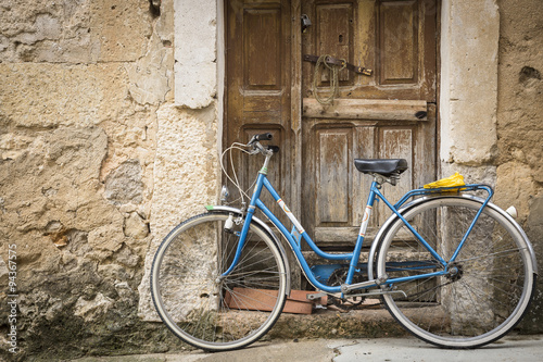 antique bicycle and an ancient wooden door