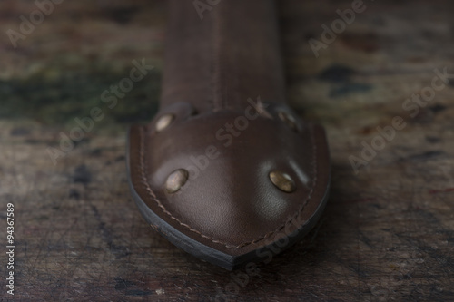 Close up photo of a dark brown leather belt made by leather goods craftsman