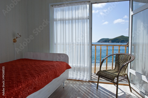 View through an open door of the sea sunny summer day.