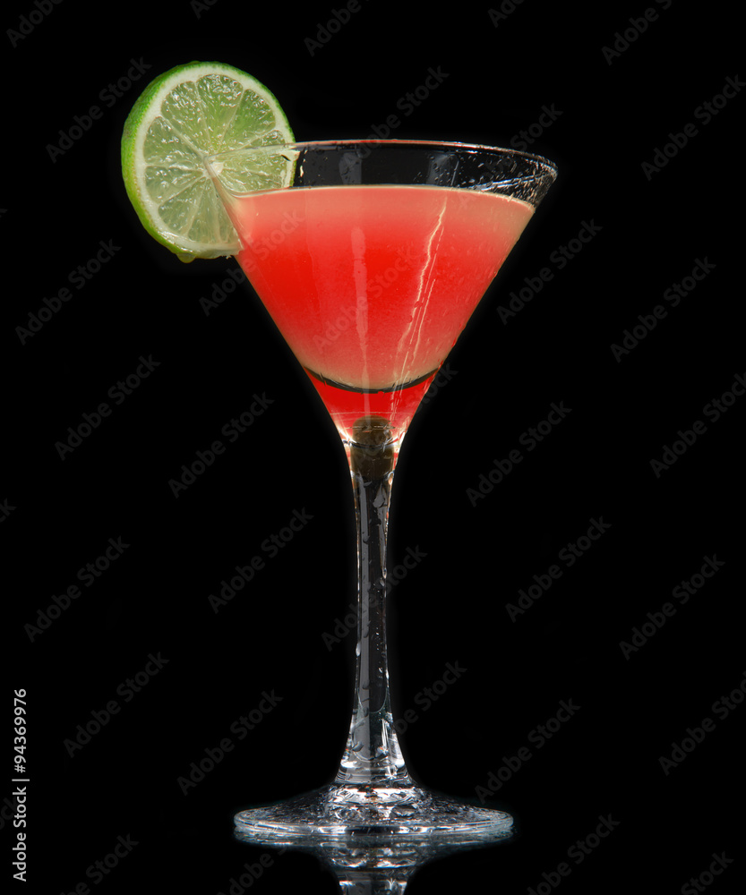 Red strawberry cocktail decorated with lime in martini Red strawberry cocktail decorated with lime in martini
