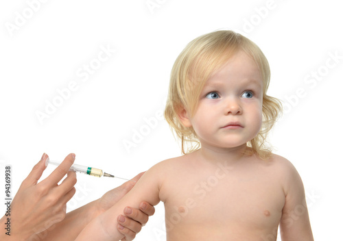 Doctor hand with syringe vaccinating child baby kid flu injectio photo