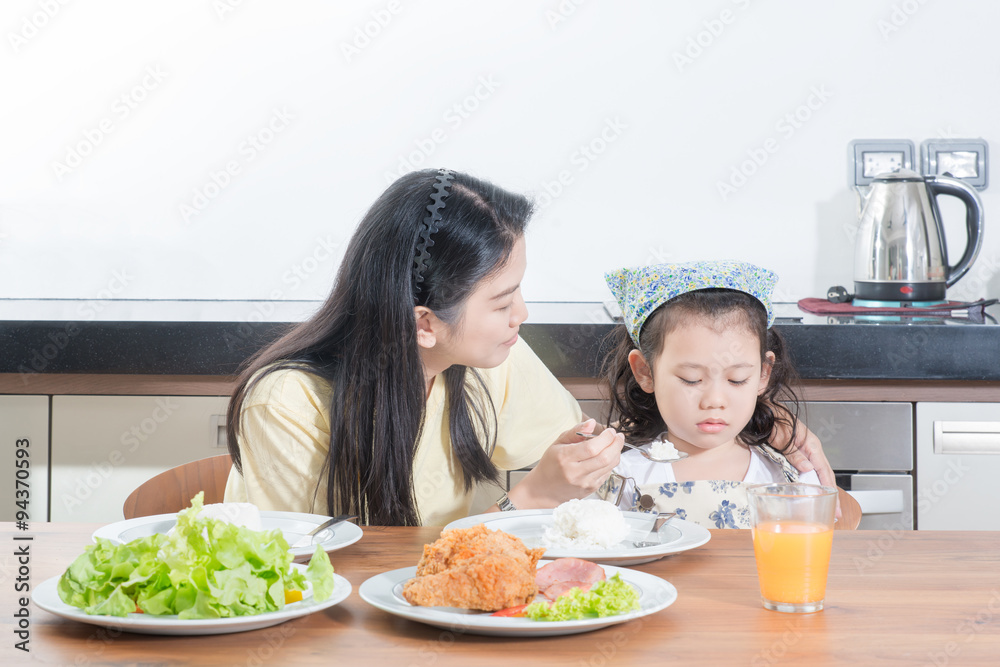 Asian girl kids with expression of disgust against eat rice whil Asian girl kids with expression of disgust against eat rice whil