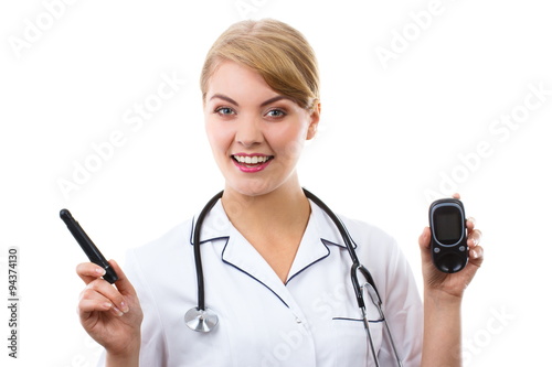 Happy woman doctor holding glucometer, measuring and checking sugar level, concept of diabetes