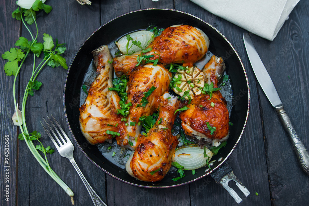 fried chicken drumsticks in a frying pan