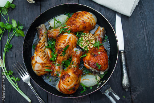 fried chicken drumsticks in a frying pan