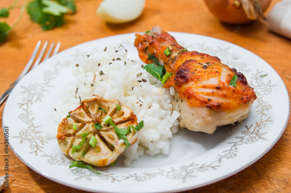 roasted chicken drumstick garnished with rice