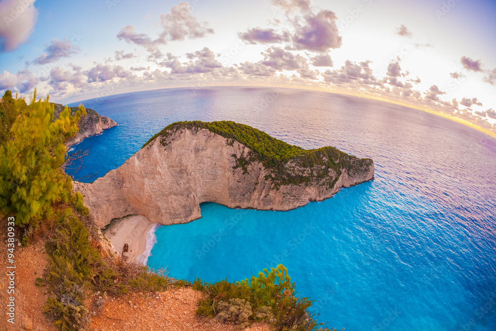 Navagio beach with shipwreck against sunset, Zakynthos island, Greece