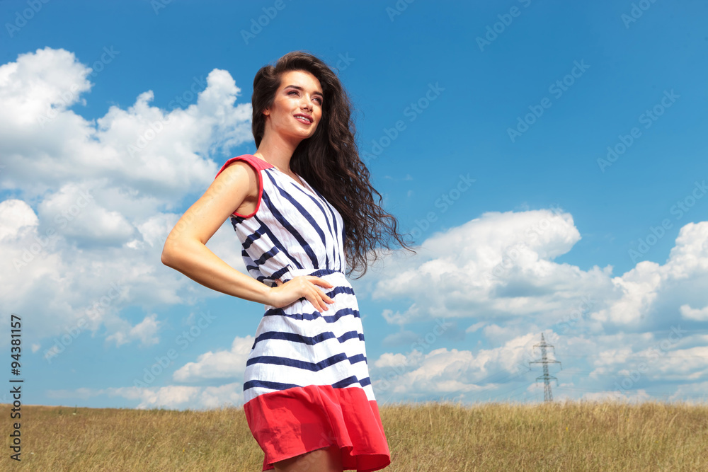 Attractive young woman smiling away from the camera Attractive young woman smiling away from the camera