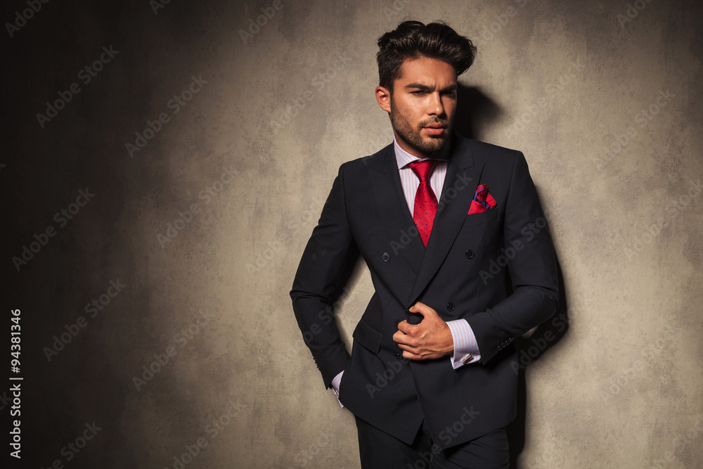 Pensive young business man opening his jacket Pensive young business man opening his jacket
