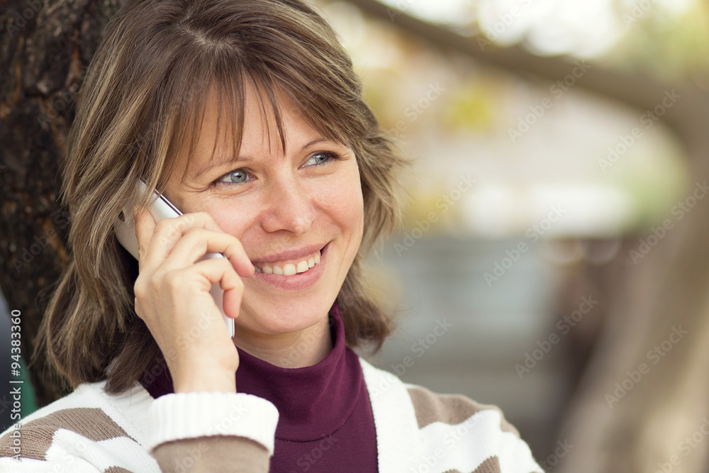 woman talking on the nature with a smartphone woman talking on the nature with a smartphone