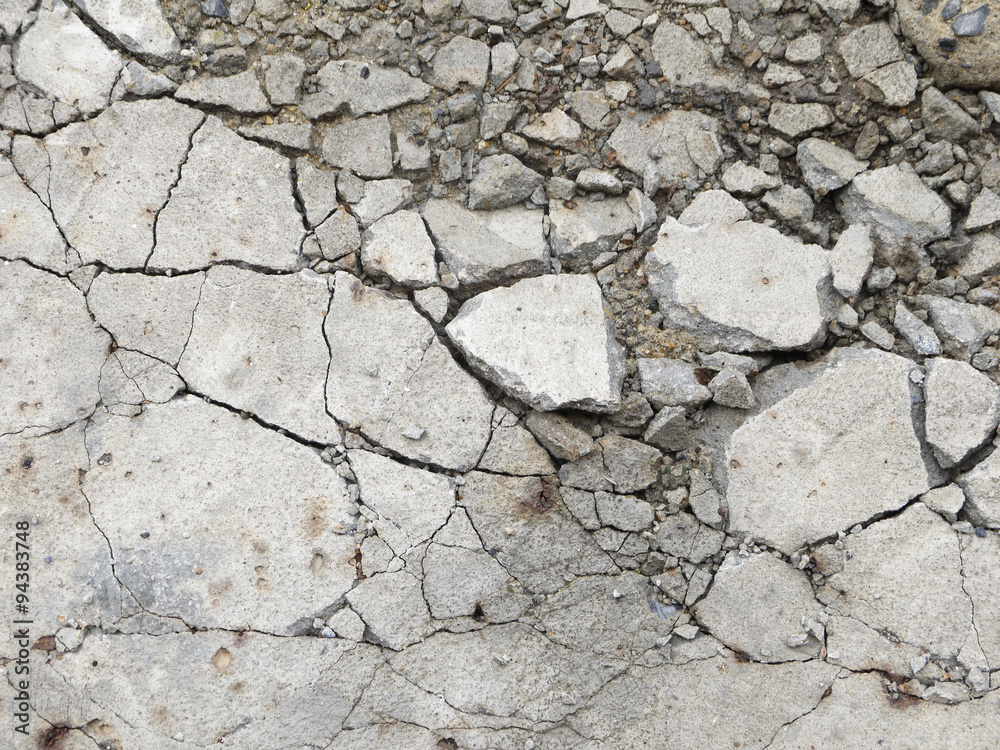 Naklejka premium A grungy fractured concrete pavement for textural background