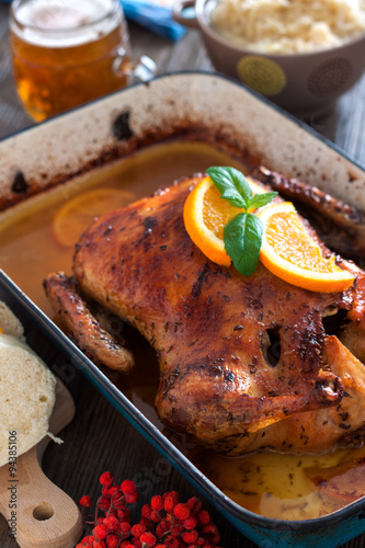Delicious roasted duck with oranges in a pan, rustic style