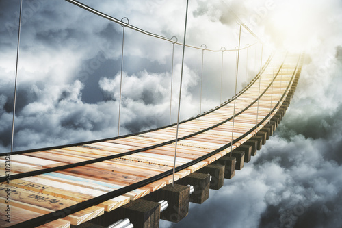 Wooden bridge in the clouds going to sunlight, concept Fototapet