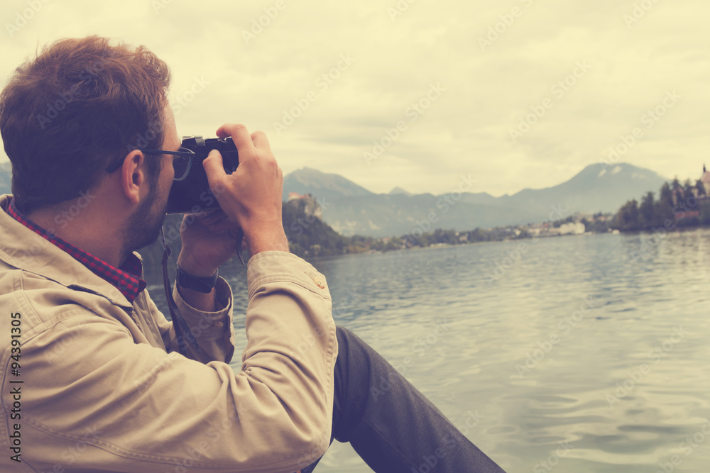 Hipster man taking photos with camera at the beach. Hipster man taking photos with camera at the beach.