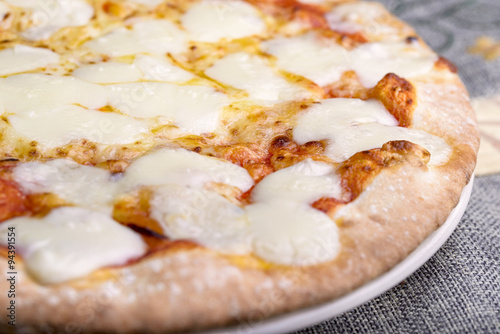 pizza tomato, mozzarella and scamorza on dish