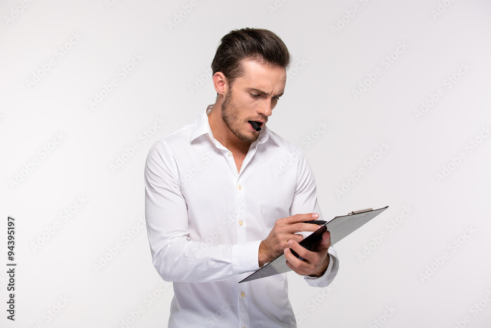 Businessman making notes on clipboard Businessman making notes on clipboard