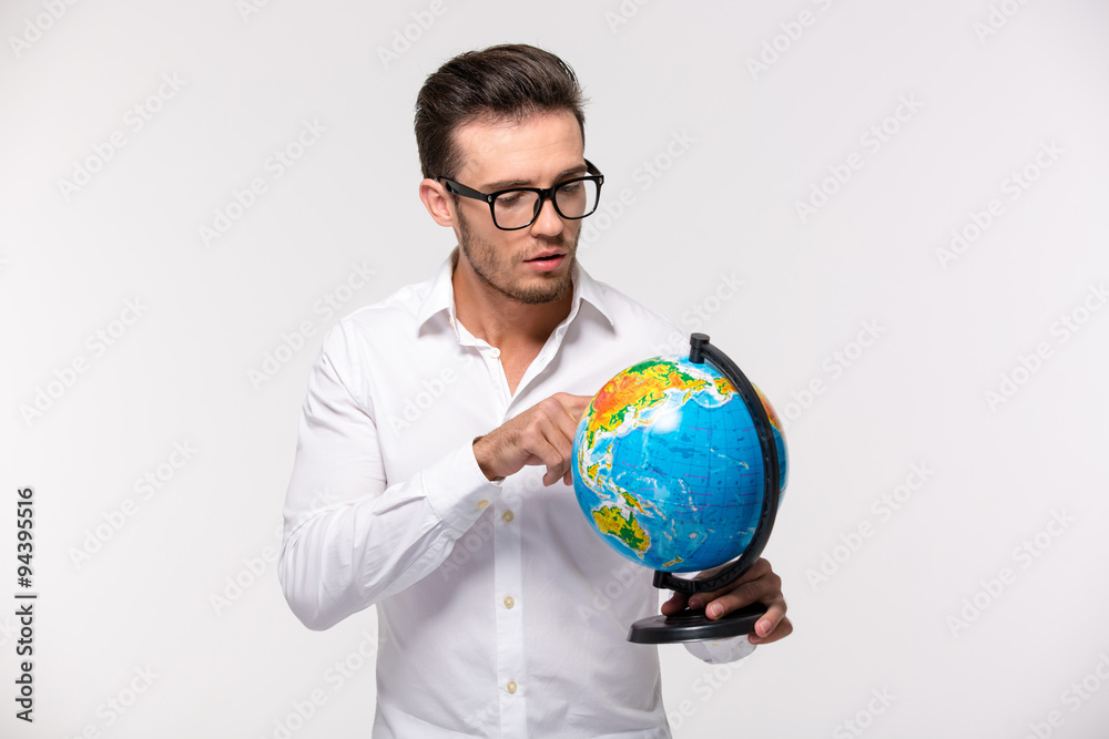 Portrait of a young businessman holding globe Portrait of a young businessman holding globe