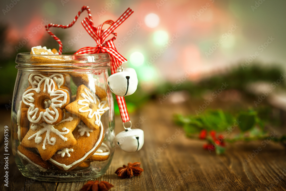 Christmas Cookies in a jar  on Wooden background with Christmas Holly