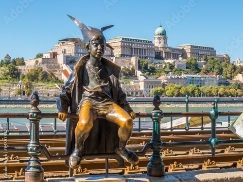 Street sculptures. Statue of the Little Princess with Buda Hill in background. Budapest, Hungary photo