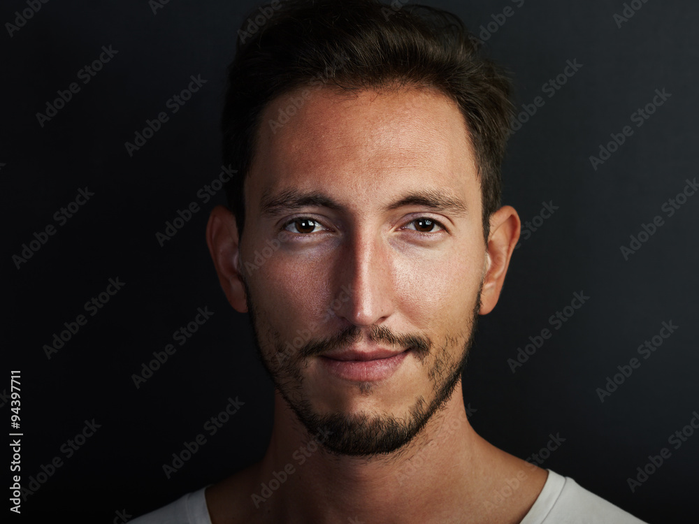 Portrait of cute young man wearing white tshirt and smiling at the camera. Horizontal Portrait of cute young man wearing white tshirt and smiling at the camera. Horizontal