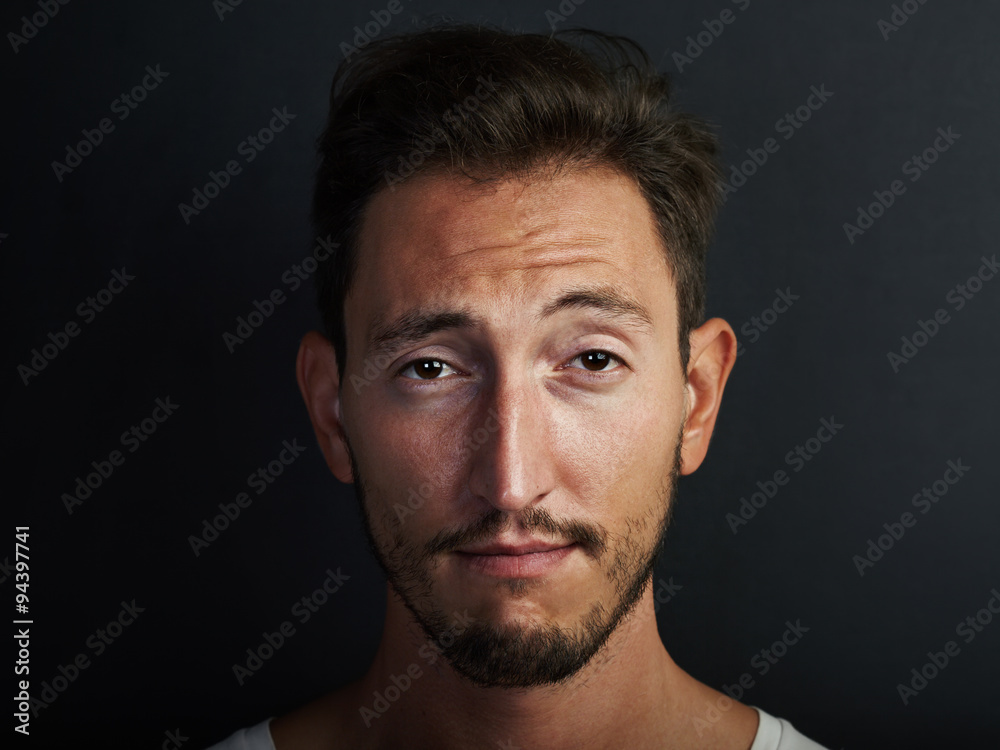 Portrait of cute young man wearing white tshirt and playing on the camera. Horizontal Portrait of cute young man wearing white tshirt and playing on the camera. Horizontal