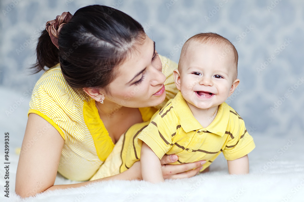Happy mother with her baby in the morning bed Happy mother with her baby in the morning bed