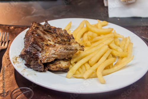 Steak with chips in restaurant in Mercado del Puerto in Montevideo, Uruguay
