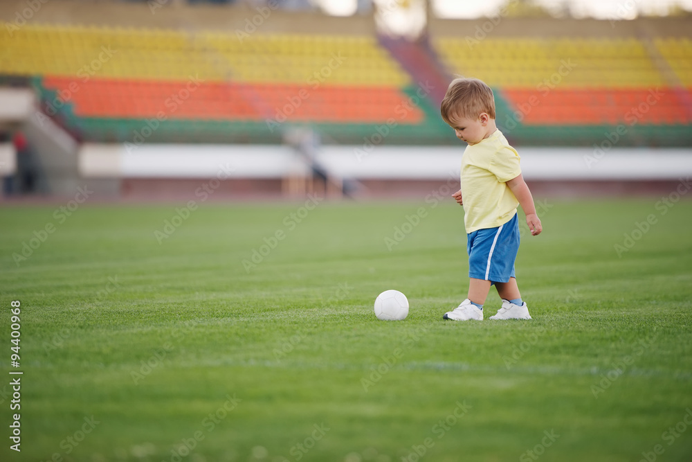 little funny boy on football stadium little funny boy on football stadium