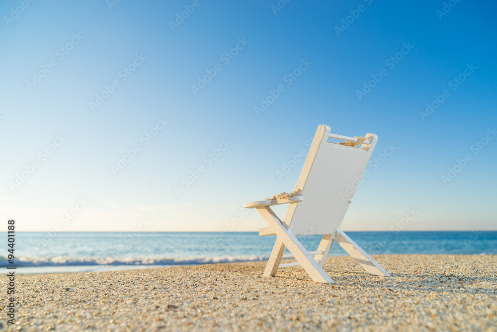 tropical beach with a sun-lounger facing the blue sea tropical beach with a sun-lounger facing the blue sea