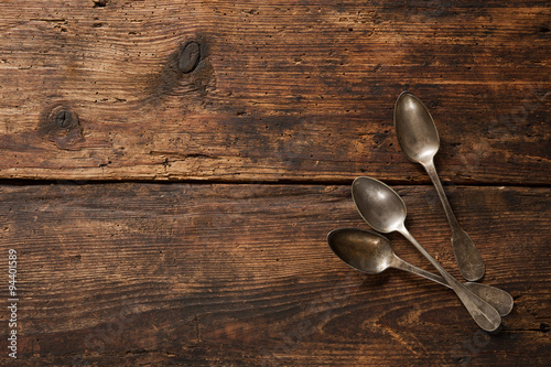 Metal spoons on wooden table