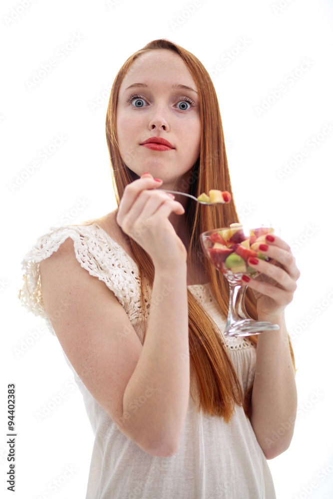 Attractive beautiful long haired woman holding a glass fruit cup Attractive beautiful long haired woman holding a glass fruit cup