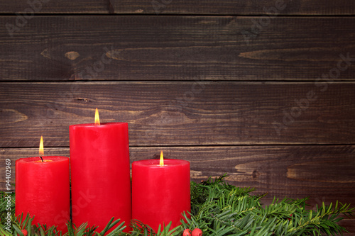 Christmas candle with wooden copy space