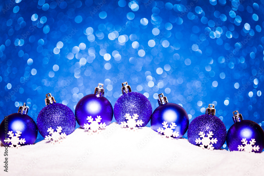 christmas blue balls in snow on glitter background christmas blue balls in snow on glitter background