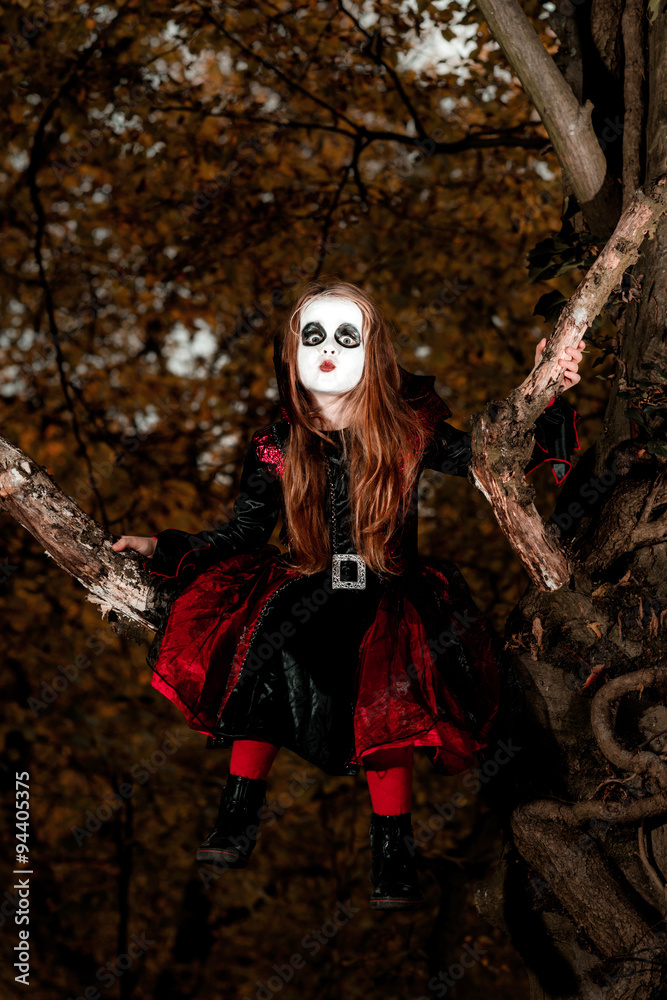 Cute little girl dressed in Halloween costume