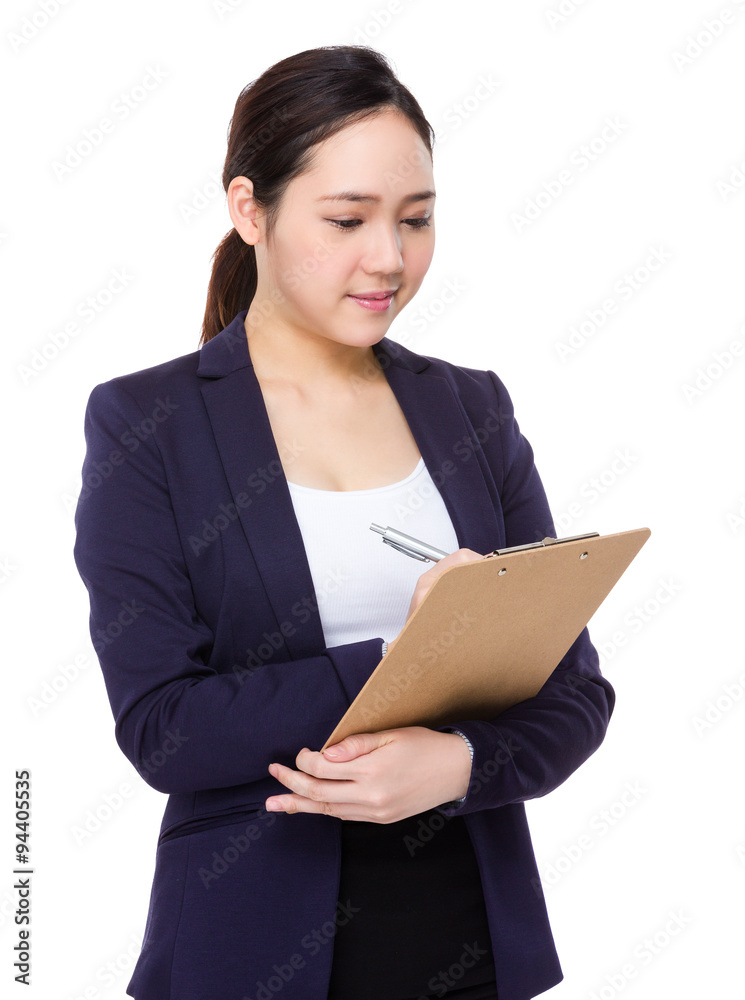 Asian businesswoman take note on clipboard Asian businesswoman take note on clipboard