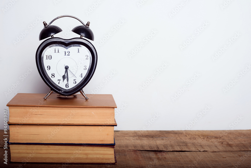 books and alarm clock on wooden background. Education equipment, education concept books and alarm clock on wooden background. Education equipment, education concept
