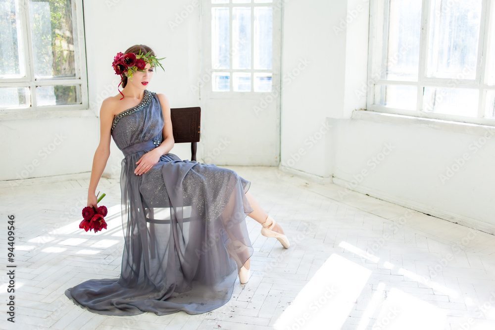 Fototapeta premium The beautiful ballerina sirtting in long gray dress 