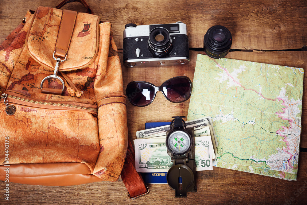 travel equipment -  map, backpack, vintage camera, sunglasses, compass, passport and money