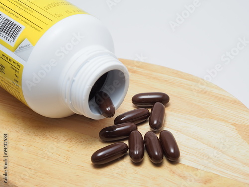 Many tablets of food supplements with bottle.