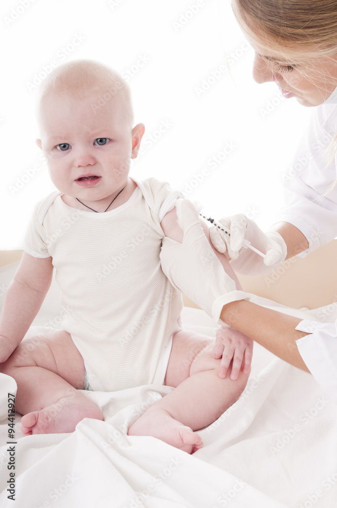 Doctor makes vaccination the child Doctor makes vaccination the child