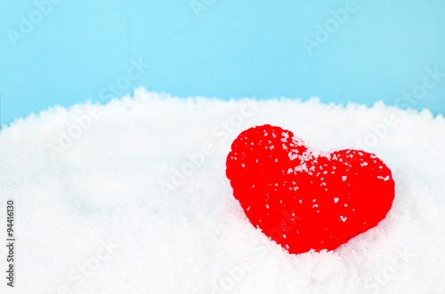Red heart shape and white snow