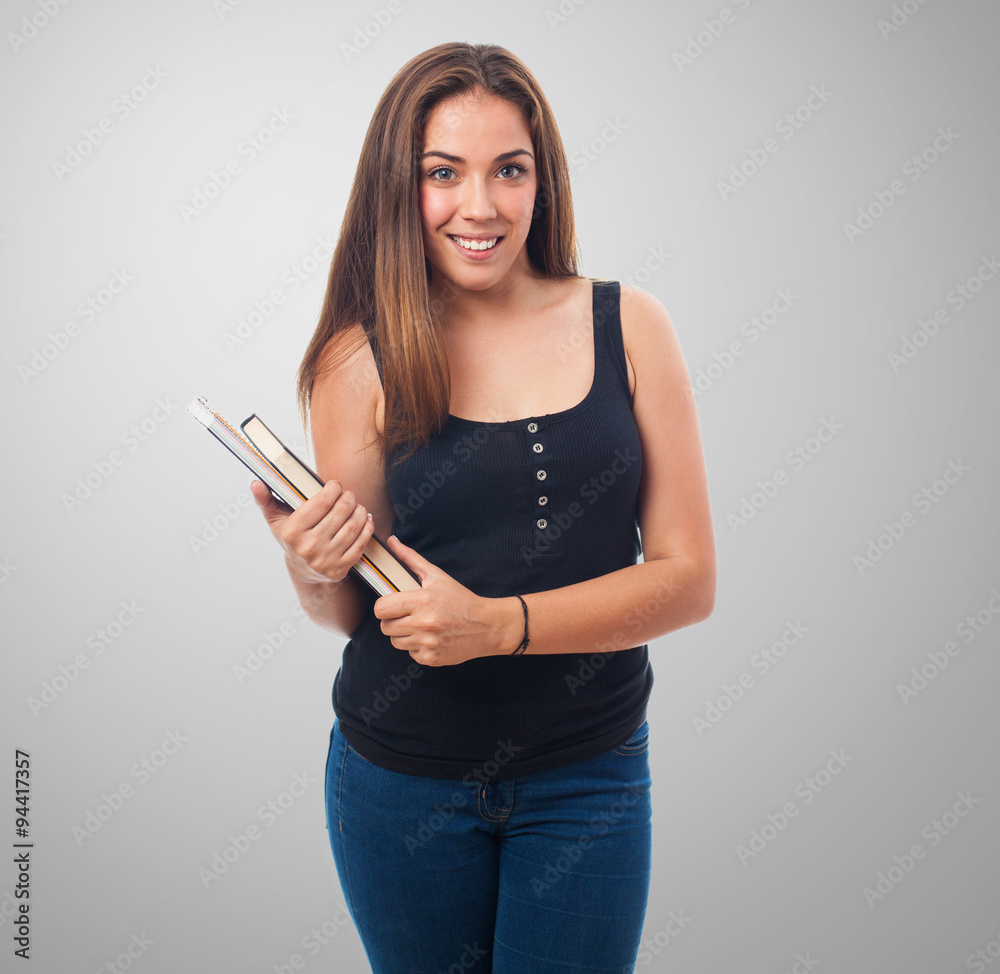 young woman holding a notebook and smiling young woman holding a notebook and smiling