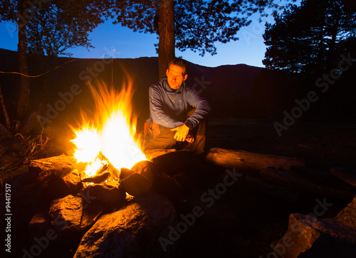 camping by fireplace by hiker