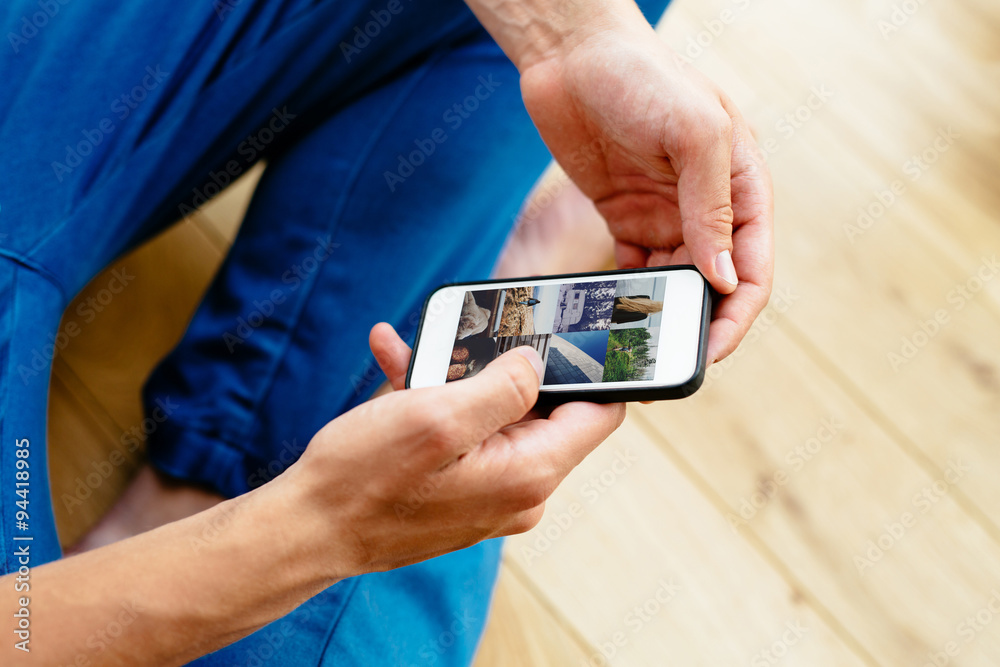 Close-up of man browsing social media on smartphone